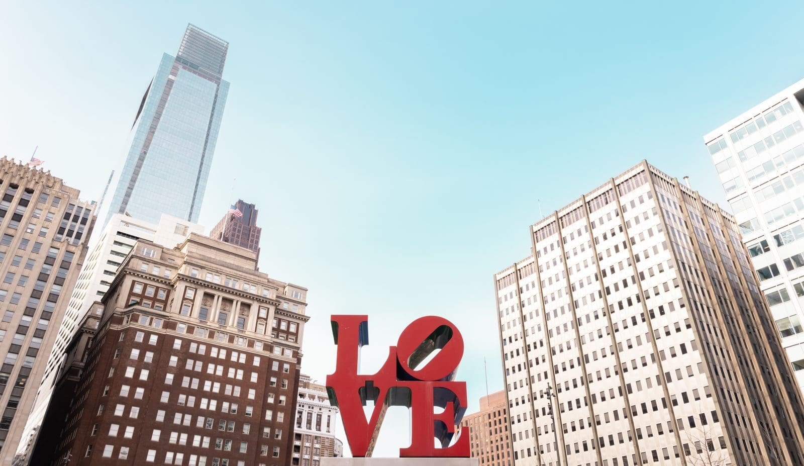 The iconic LOVE sculpture against Philadelphia's downtown skyline on a clear day.